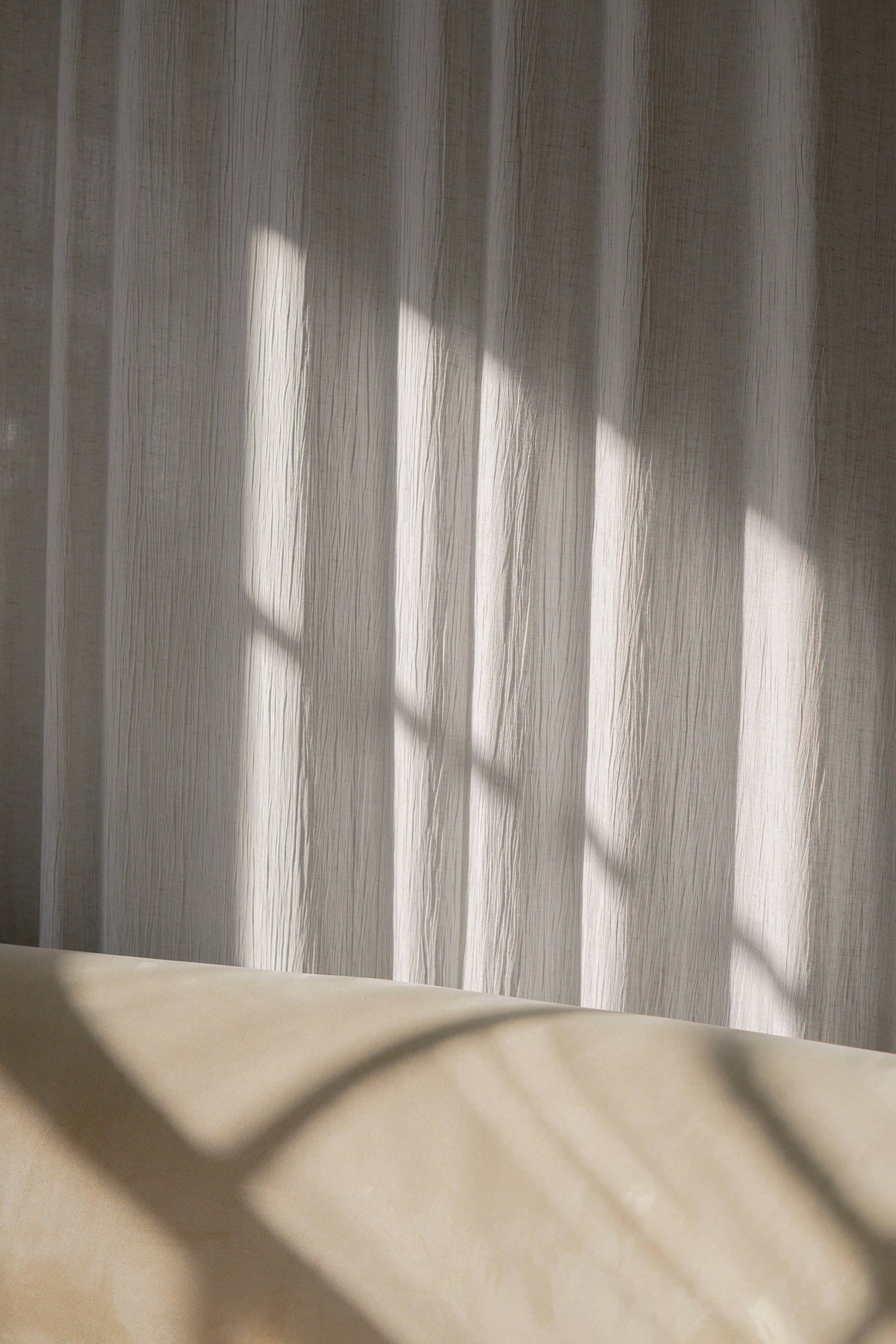 Soft daylight falling through a linen curtain in a quiet room